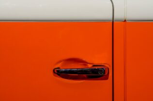 Close up of orange car door handle