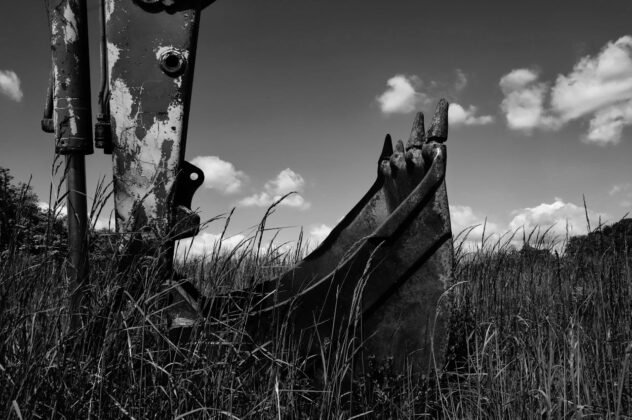 Industrial excavator bucket in a field