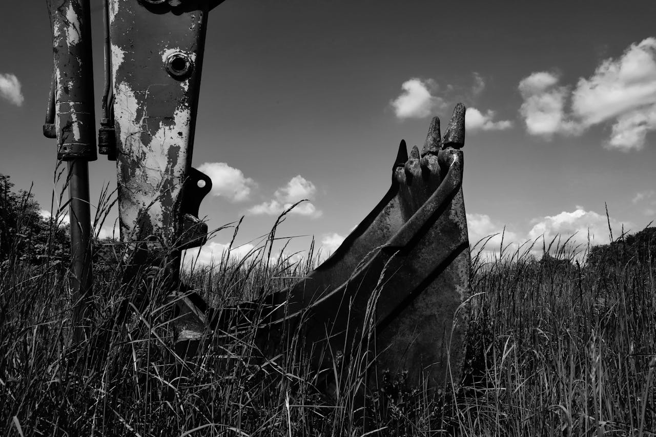 Industrial excavator bucket in a field