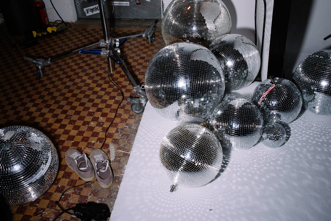 Different sizes of disco balls on the floor