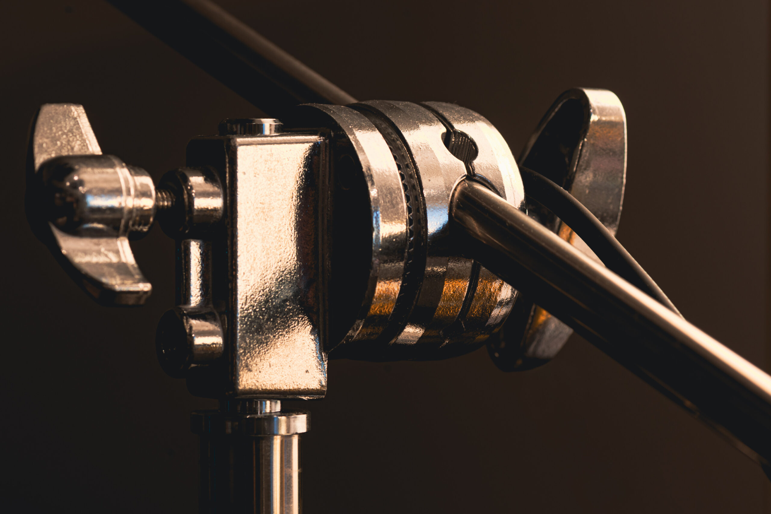 Tight shot of a production C stand clamp, used to hold up lighting and microphones in a video studio 
