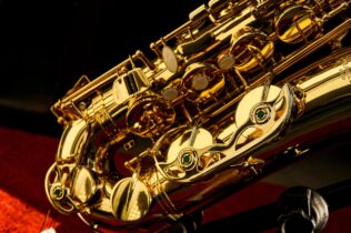 Closeup of shiny gold saxophone.