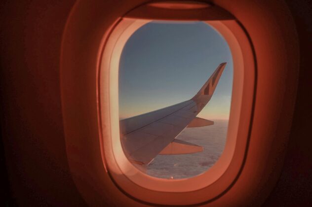 Airplane wing seen through airplane window