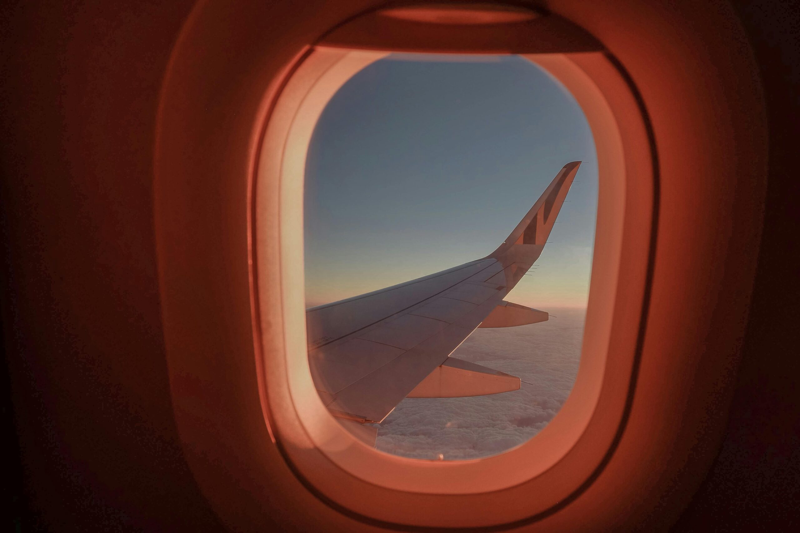 Airplane wing seen through airplane window