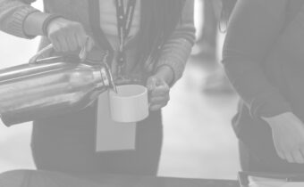 Closeup of someone pouring coffee into a cup